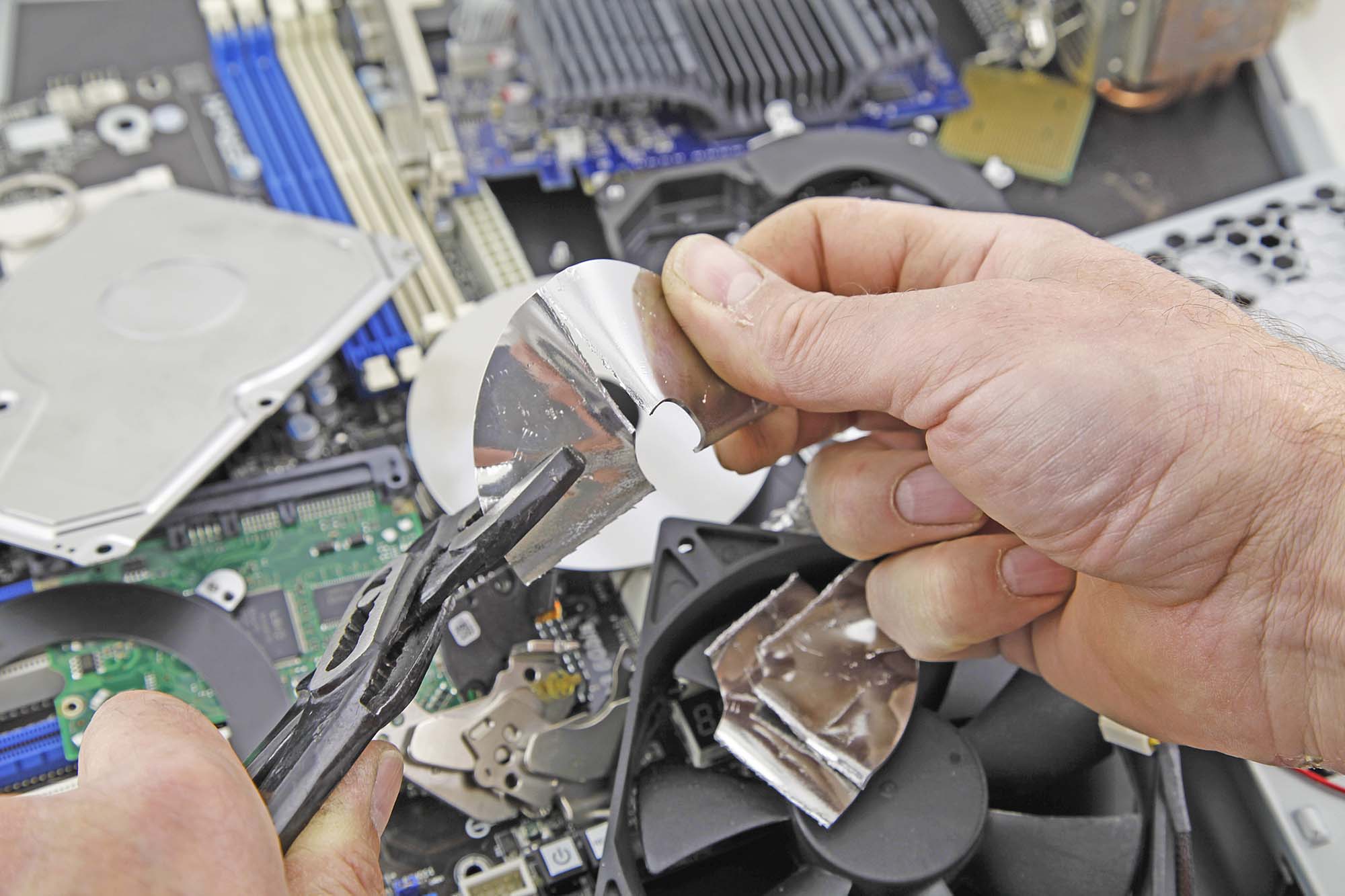 man deconstructing Hard Drive