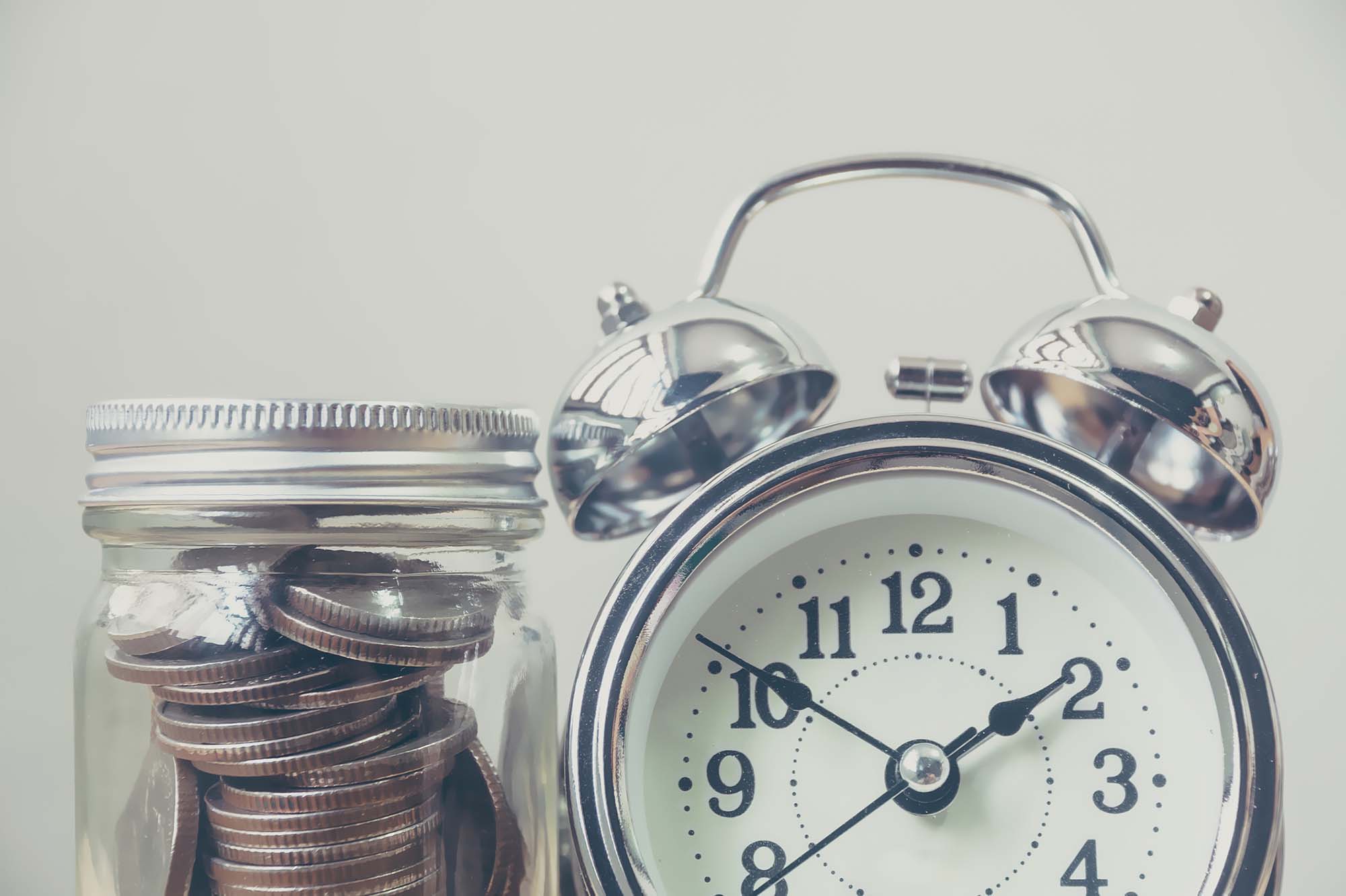 Money coin in jar with clock, Concept save money and time management Money coin in jar with clock, Concept save money and time management